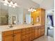 Bright bathroom featuring double sinks, vanity, and large mirror at 132 Mantle Dr, Clayton, NC 27527