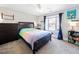 Comfortable bedroom with dark wood bed frame, dresser, and ceiling fan at 132 Mantle Dr, Clayton, NC 27527