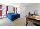 Bedroom with a blue bedspread, ceiling fan, and modern desk setup at 132 Mantle Dr, Clayton, NC 27527