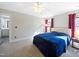 Comfortable carpeted bedroom with natural light, a ceiling fan, and neutral walls at 132 Mantle Dr, Clayton, NC 27527
