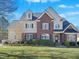 Beautiful brick home with light siding and a well-manicured lawn on a sunny day at 132 Mantle Dr, Clayton, NC 27527