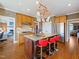 Spacious kitchen featuring a central island, stainless steel refrigerator, and warm wooden cabinetry at 132 Mantle Dr, Clayton, NC 27527