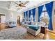 Bright living room featuring coffered ceilings, large windows with blue drapes, and comfortable seating at 132 Mantle Dr, Clayton, NC 27527