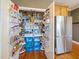 Organized walk-in pantry with extensive shelving and stainless steel refrigerator at 132 Mantle Dr, Clayton, NC 27527