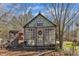 Exterior view of quaint potting shed with vintage accents, set in a picturesque backyard at 1384 Sims Bridge Rd, Kittrell, NC 27544