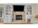 Close up of a stone fireplace with built-in shelves, perfect for cozy evenings at 1384 Sims Bridge Rd, Kittrell, NC 27544