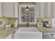 Close-up of kitchen sink with granite countertops and stainless steel appliances at 1384 Sims Bridge Rd, Kittrell, NC 27544