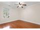 Bedroom featuring hardwood floors, light walls, and a bright window overlooking the outdoors at 1408 Hunters Point Way, Cary, NC 27511