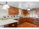 Spacious kitchen featuring wooden cabinetry, stainless steel appliances, and tile backsplash at 1408 Hunters Point Way, Cary, NC 27511