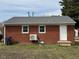 Brick home featuring access to the backyard at 1421 Deer Crossing Ct, Henderson, NC 27536