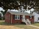 Charming brick home featuring a well-maintained front yard and inviting entrance at 1421 Deer Crossing Ct, Henderson, NC 27536