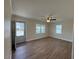 Bright living room featuring hardwood floors, a ceiling fan, and natural light at 1421 Deer Crossing Ct, Henderson, NC 27536