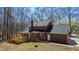 Charming brick home showcasing a spacious deck and sunroom in a serene backyard setting at 1500 Allen Ln, Hillsborough, NC 27278