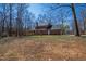 Spacious backyard featuring mature trees and lush greenery surrounding the house at 1500 Allen Ln, Hillsborough, NC 27278