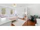 Bedroom boasts white walls, a ceiling fan, wood floors, and a sunny window at 1500 Allen Ln, Hillsborough, NC 27278