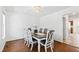 Well-lit dining room with a large wooden table and seating for six, ideal for Gathering meals and entertaining at 1500 Allen Ln, Hillsborough, NC 27278