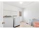 Well-lit laundry room features modern washer, dryer, utility sink and convenient exterior access at 1500 Allen Ln, Hillsborough, NC 27278