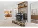 Cozy living room with stone fireplace and access to a sunroom and kitchen at 1500 Allen Ln, Hillsborough, NC 27278