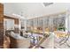 Bright sunroom with wicker furniture and access to the deck at 1500 Allen Ln, Hillsborough, NC 27278