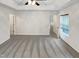 Spacious bedroom with neutral gray carpet, white walls, a ceiling fan, and an open door at 1501 Copper Cir, Mebane, NC 27302