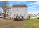 Back exterior view showcases a well-maintained yard and a charming deck at 153 N Farm Dr, Clayton, NC 27527