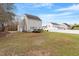 Spacious backyard with deck and manicured lawn, perfect for outdoor gatherings at 153 N Farm Dr, Clayton, NC 27527