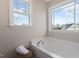 Bright bathroom showcasing a soaking tub with a window view and plush white towels at 153 N Farm Dr, Clayton, NC 27527