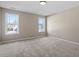 Spacious bedroom with carpet, two windows for ample natural light, and neutral walls at 153 N Farm Dr, Clayton, NC 27527