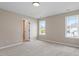 Bedroom with neutral colors, carpet, and large windows to the outside at 153 N Farm Dr, Clayton, NC 27527