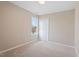 Cozy bedroom with neutral carpet, a window providing natural light, and a closet at 153 N Farm Dr, Clayton, NC 27527