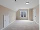 Large bonus room with sloped ceilings, neutral carpet, and a window for natural light at 153 N Farm Dr, Clayton, NC 27527
