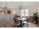 Dining room featuring wood floors, modern lighting, neutral colors, and large windows at 153 N Farm Dr, Clayton, NC 27527