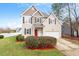 Charming two-story home features a red front door, well-maintained landscaping, and an attached garage at 153 N Farm Dr, Clayton, NC 27527
