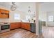 Kitchen with stainless appliances, wood cabinets, and bright, light countertops at 153 N Farm Dr, Clayton, NC 27527