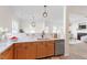 Kitchen with stainless appliances, wood cabinets, and bright, light countertops at 153 N Farm Dr, Clayton, NC 27527