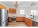 Kitchen with stainless appliances, wood cabinets, and bright, light countertops at 153 N Farm Dr, Clayton, NC 27527