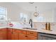Kitchen with stainless appliances, wood cabinets, and bright, light countertops at 153 N Farm Dr, Clayton, NC 27527