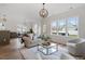 Bright living room features hardwood floors, recessed lights, neutral paint, and a cozy seating arrangement at 153 N Farm Dr, Clayton, NC 27527