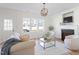 Bright living room with fireplace, modern lighting, neutral walls, and views to the outside at 153 N Farm Dr, Clayton, NC 27527