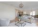 Open concept living room with hardwood floors, neutral colors, and modern light fixture at 153 N Farm Dr, Clayton, NC 27527