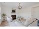 Stylish living room featuring hardwood floors, white trim, a fireplace, and an elegant light fixture at 153 N Farm Dr, Clayton, NC 27527