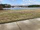 Scenic water view homes feature lush landscaping with a backdrop of a beautiful blue sky at 153 N Farm Dr, Clayton, NC 27527