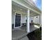 Inviting front porch with craftsman-style columns and stone accents, creating a welcoming entrance at 1560 Bright Coral Trl, Wendell, NC 27591