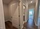 Hallway with hardwood floors leading to a bathroom and additional rooms at 1560 Bright Coral Trl, Wendell, NC 27591