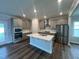 Modern kitchen with stainless steel appliances, a center island, and ample cabinet space at 1560 Bright Coral Trl, Wendell, NC 27591