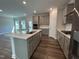 Modern open-concept kitchen with a center island and stainless steel appliances at 1560 Bright Coral Trl, Wendell, NC 27591