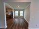 Bright living room space adjacent to an open kitchen, with hardwood floors and natural light at 1560 Bright Coral Trl, Wendell, NC 27591