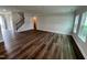 Large living room with natural light, hardwood floors, and staircase leading to the upper level at 1560 Bright Coral Trl, Wendell, NC 27591