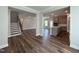 Open-concept living room with hardwood floors seamlessly connects to the kitchen with an island at 1560 Bright Coral Trl, Wendell, NC 27591