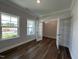 Office featuring hardwood floors, white trim, and many windows for natural light at 1560 Bright Coral Trl, Wendell, NC 27591